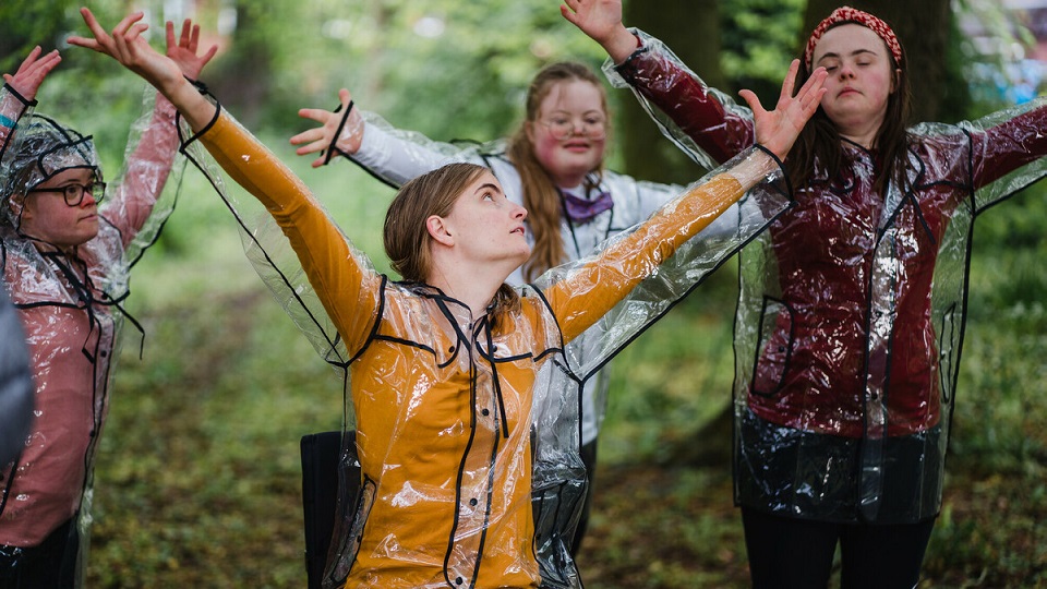 A group of disabled children dancing in the rain